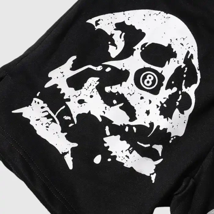 Hellstar Studios Shorts in black feature a distinctive white skull design that creatively incorporates an 8 ball, forming a unique and edgy pattern against the dark backdrop.