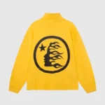 The Hellstar Studios Zipper Sweater in yellow showcases a large black circular design on the back, featuring a silhouette of a face with flame-like hair and a star against a plain gray background.